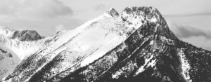 A black and white photo of a mountain covered in snow.