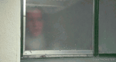 A person standing in front of a window.