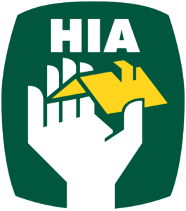 The hia logo with a hand holding a house.