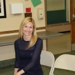 A woman sitting on a chair in a room.