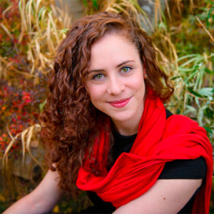 A woman wearing a red scarf.