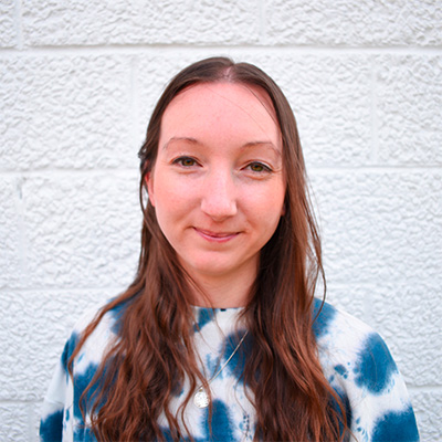 A woman wearing a tie dye shirt.