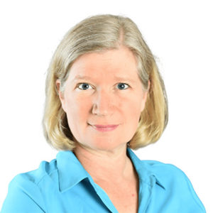 A woman in a blue shirt is posing for a photo.