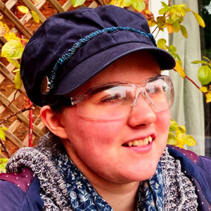 A woman wearing glasses and a scarf.