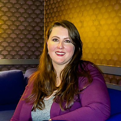 A woman sitting on a blue couch.
