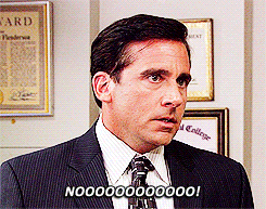 A man in a suit stands in an office, looking distressed and saying "NOOOOOOOOOOO!" with an upset expression.