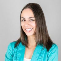 Copywriter, Jenna Click, smiles in a turquoise blazer. Copywriter, Jenna Click, smiles in a turquoise blazer.